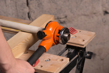 manual pipe threading on a workbench
