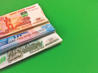 Money rubles pack on a green isolated background. Russian banknotes one thousand, five thousand,...
