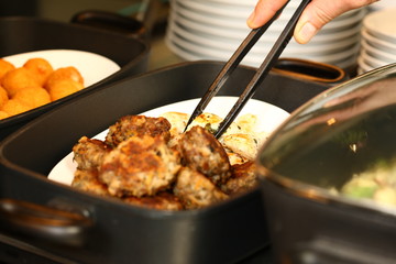 professional cook in kitchen preparing food for customers showing hands and utilities