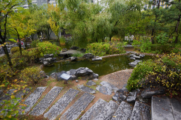 Fototapeta na wymiar Pagoda reflecting in a pond at the Lan Su Chinese Garden, in Portland, southern korea