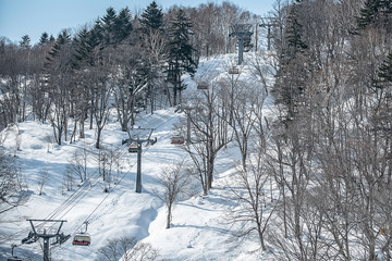 Panoramic view of driving directions With trees and mountains covered in snow