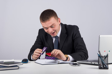 Portrait happy excited surprised young businessman about to open unwrap  gift box
