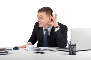Young businessman holds his hand near ear