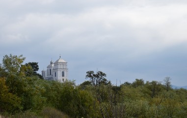 white orthodox church on the hill