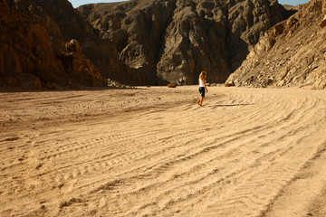 blond femal model walking in desert sand