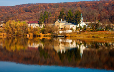 Magnificent landscape with a view of the lake in autumn and the monastery