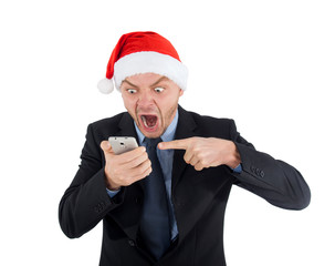 Angry businessman in santa claus hat is talking on the phone and screams of joy