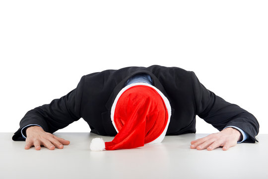 Businessman With Santa Hat Sleeping On Desk Office After Christmas Party And Happy New Year