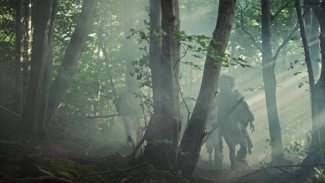 Tribe of Hunter-Gatherers Wearing Animal Skin Holding Stone Tipped Tools, Explore Prehistoric Forest in a Hunt for Animal Prey. Neanderthal Family Hunting in the Jungle or Migrating for Better Land