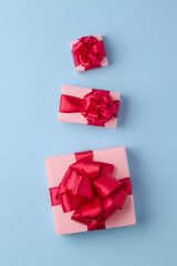 Three pink boxes on a light blue paper background.