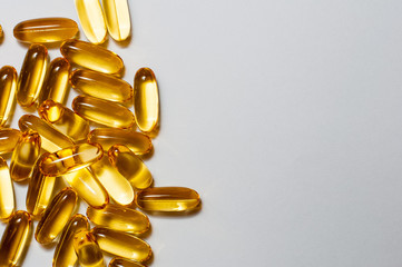 Close up of food supplement oil filled capsules suitable for: fish oil, omega 3, omega 6, omega 9,...