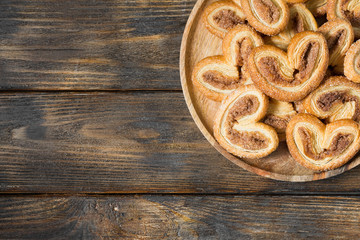Puff pastry with sugar and cinnamon in a rustic style. Space for text