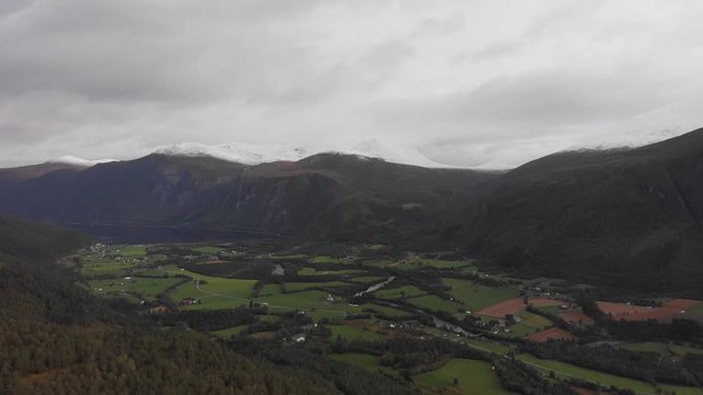 Aerial shot of a small town in the beautiful Norwegian mountain valley landscape near Eresfjord, Norway
