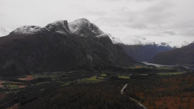 Aerial shot of a snow capped mountain range on an overcast day. Eresfjord, Norway.