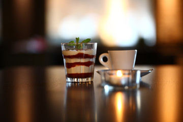 coffee and desert on a table with candle