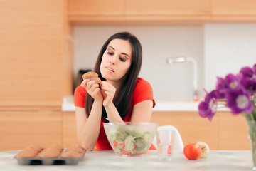 Obraz na płótnie Canvas Woman Eating a Cupcake instead of Apples or Salad