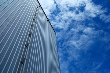 Fototapeta na wymiar Warehouse Wall with Blue Sky Background.