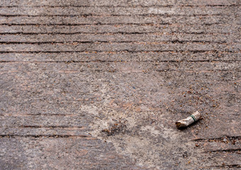 The cigarette butt let down on the concrete floor
