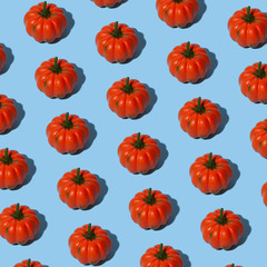 Conceptual halloween pattern with decorative pumpkin on a blue background.