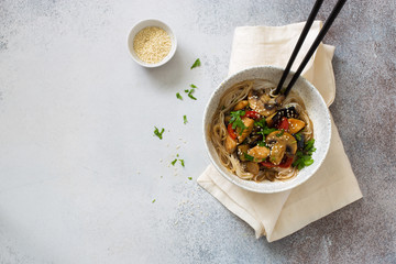 Rice noodles with mushrooms and vegetables close up