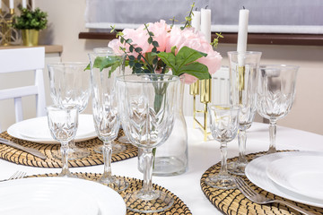 banquet table served with instruments and decorated with empty wine glasses