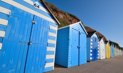 Fototapeta na wymiar Row of colourful beach huts in Seaton, Devon