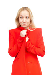 Blonde girl with a sly expression in red clothes on a white background.