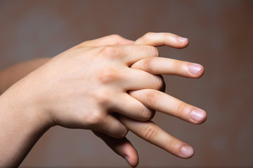 Human with fingers interlocked gesture close up