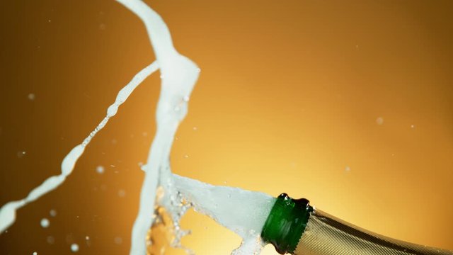 Super Slow Motion Shot of Champagne Explosion on Golden Luxury Background at 1000fps.