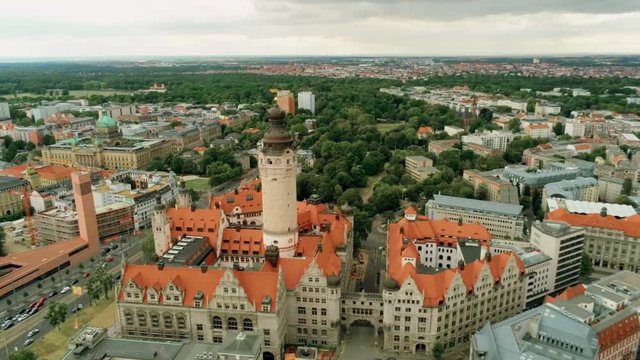 Aerial Panorama of Leipzig's Old Town Skyline, Germany, Europe. New Town Hall - Neues Rathaus - Monumental Building in style of German Late Renaissance. 4K Background Amazing Drone Pull out Shot