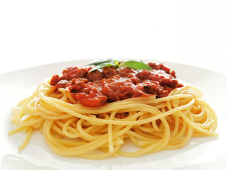 Spaghetti Bolognese with minced beef, onion, chopped tomato, garlic, olive oil, stock cube, tomato puree and Italian herb. Traditional Italian food in a white plate on white background.