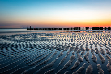 Beautiful Sunset reflection on the beach in the Netherlands