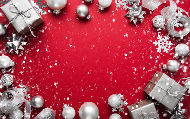 Christmas and New Year holiday background. Xmas greeting card. Christmas silver ornaments on red...