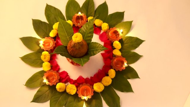 Copper Kalash with coconut , leaf and floral decoration on a white background. essential in hindu puja.
