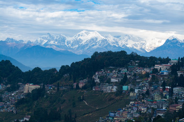 Darjeeling City on hill with mountains and clouds background, India