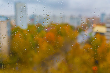 Cloudy rainy day at autumn in Moscow city (Russia). Sudden cold snap, drops on window glass and cityscape