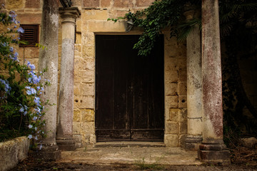A wooden door of an old abandoned house