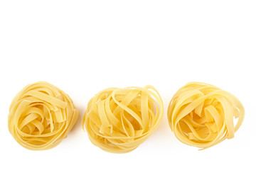 Italian rolled Raw noodles. Pasta isolated on white background . Egg homemade dry ribbon noodles, long rolled macaroni or uncooked spaghetti isolated.