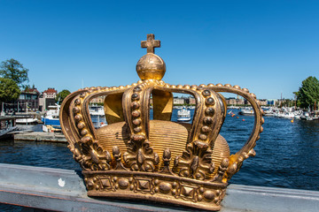 Fototapeta na wymiar Gilded crown on the Skeppsholmsbron bridge in Stockholm, Sweden, Europe