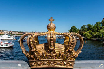 Fototapeta na wymiar Gilded crown on the Skeppsholmsbron bridge in Stockholm, Sweden, Europe