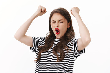 Lucky enthusiastic cheerful young woman win lots money, close eyes happy rejoicing stunning news,...