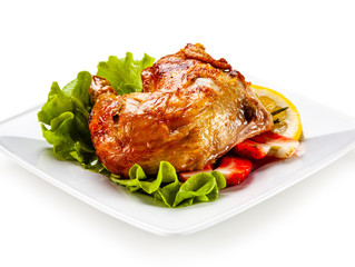 Grilled chicken leg with vegetables on white background