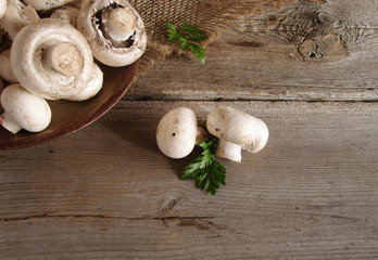 Champignon and parsley on a wooden table