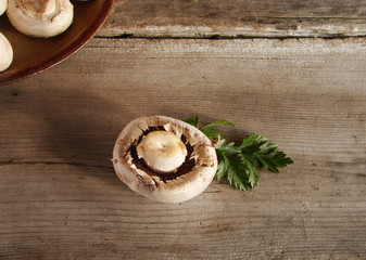 Champignon and parsley on a wooden table