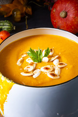 Pumpkin cream soup with roasted pumpkin seeds and seed oil