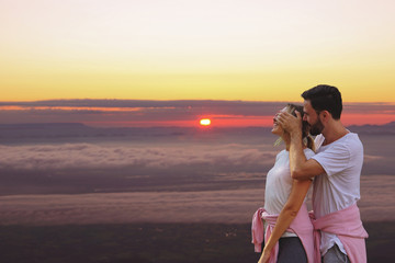 Couples on a scenic spot,view point  by a young man are closing the eyes girlfriend on Sunrise and...