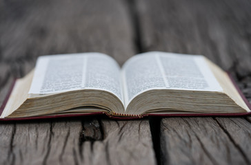 Open bible on wood background