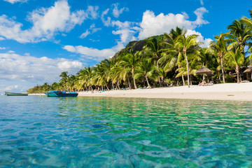 Luxury beach in Mauritius. Transparent ocean, white sand beach, palms and sky
