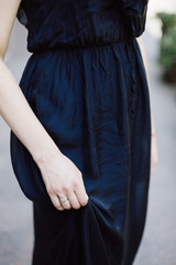 the girl holds a dress detail 