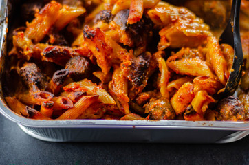 Penne pasta in a tomato and basil sauce with British pork and beef meatballs topped with mature Cheddar cheese